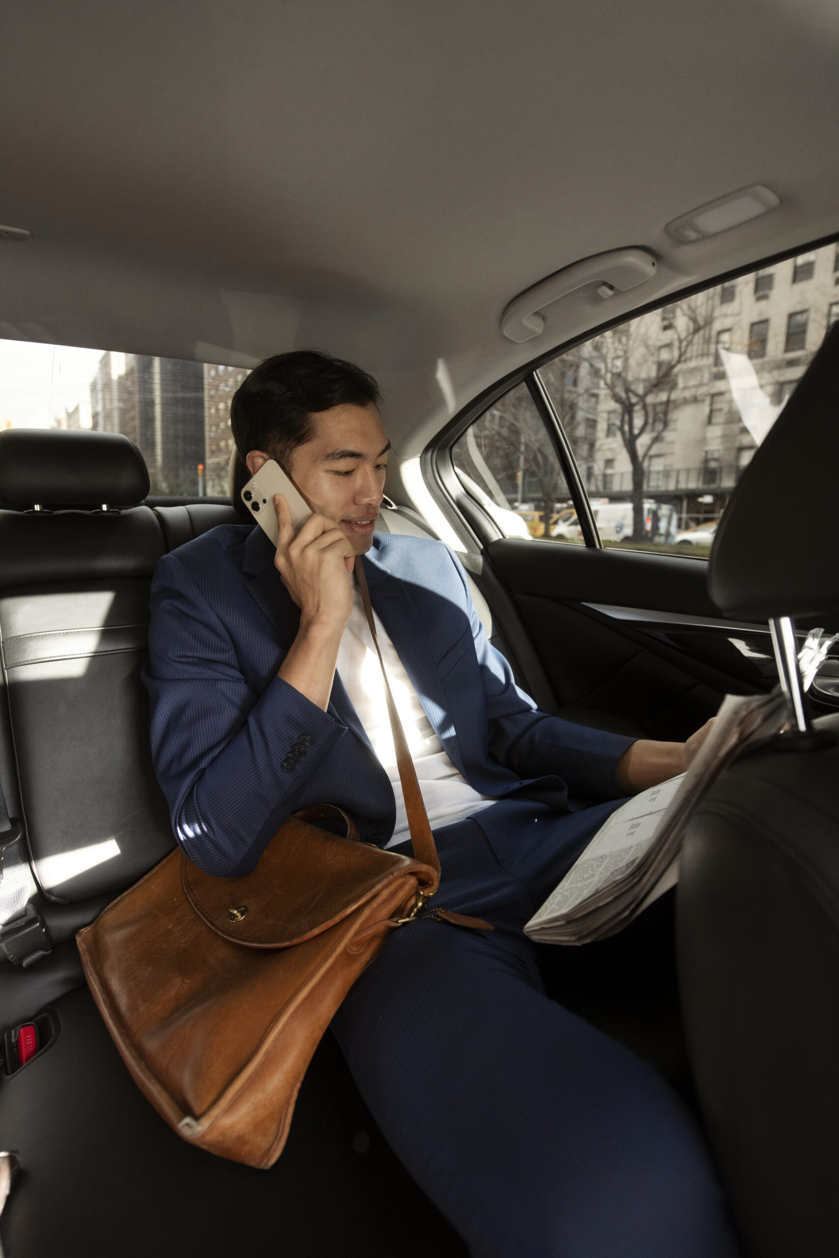 Passenger talking on phone while reading