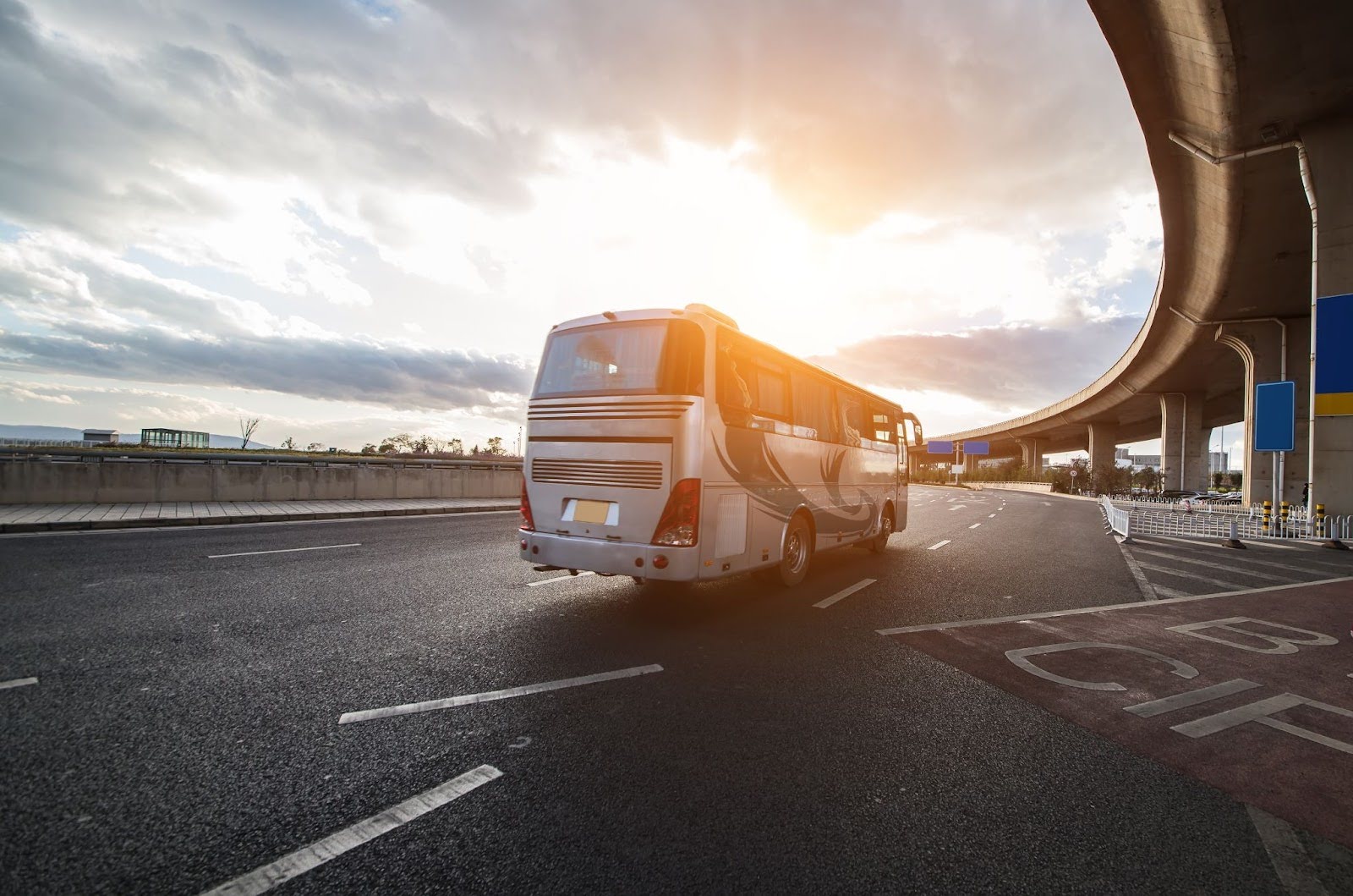 Rear view of a silver airport shuttle bus